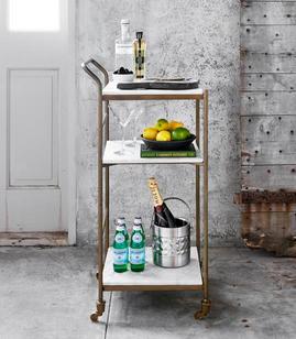 marble top bar cart with glasses and bottles