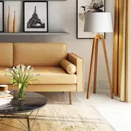 tan leather sofa with coffee table and lamp