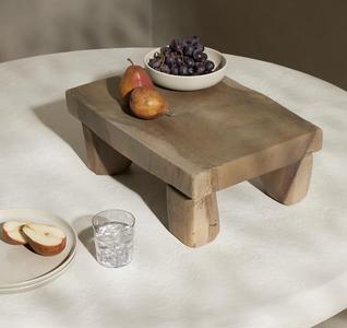 stone table with plates glass and fruit